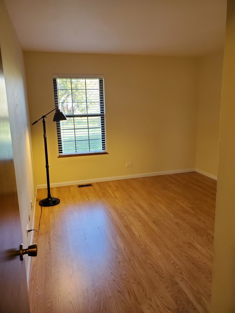 726 Chandler Road Gurnee, IL 60031 - Photo 12 of 43 wooden floor in an empty room with a window