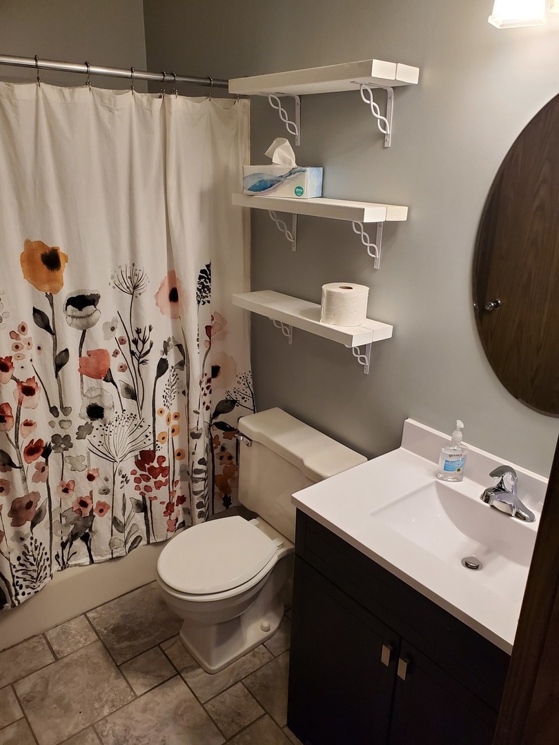 726 Chandler Road Gurnee, IL 60031 - Photo 14 of 43 a bathroom with a sink a toilet and shower curtain