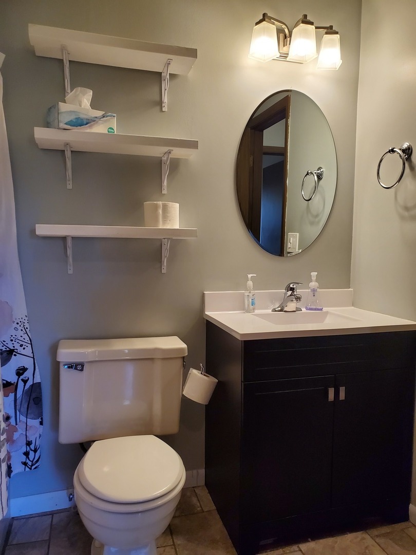 726 Chandler Road Gurnee, IL 60031 - Photo 15 of 43 a bathroom with a toilet sink vanity and mirror