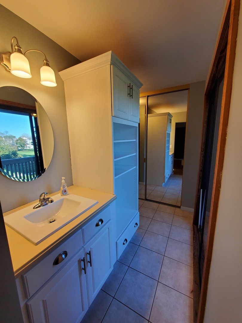 726 Chandler Road Gurnee, IL 60031 - Photo 22 of 43 a bathroom with a double vanity sink and mirror