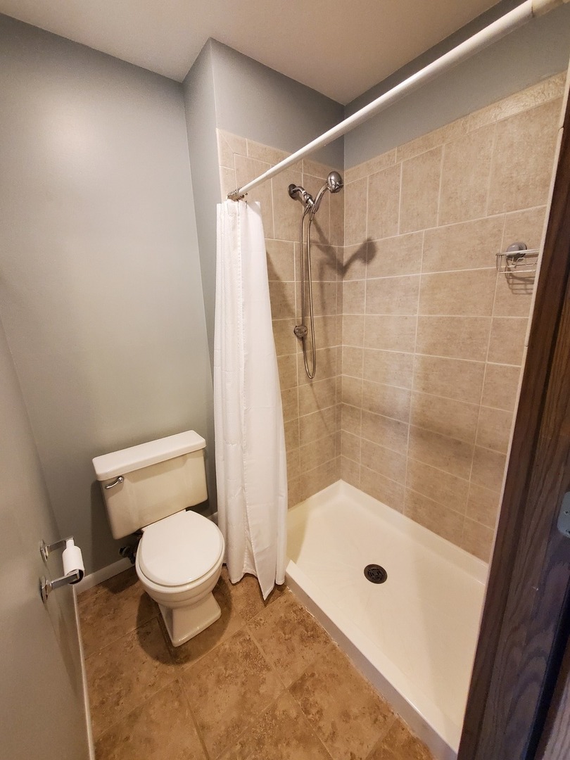 726 Chandler Road Gurnee, IL 60031 - Photo 25 of 43 a bathroom with a shower and a toilet