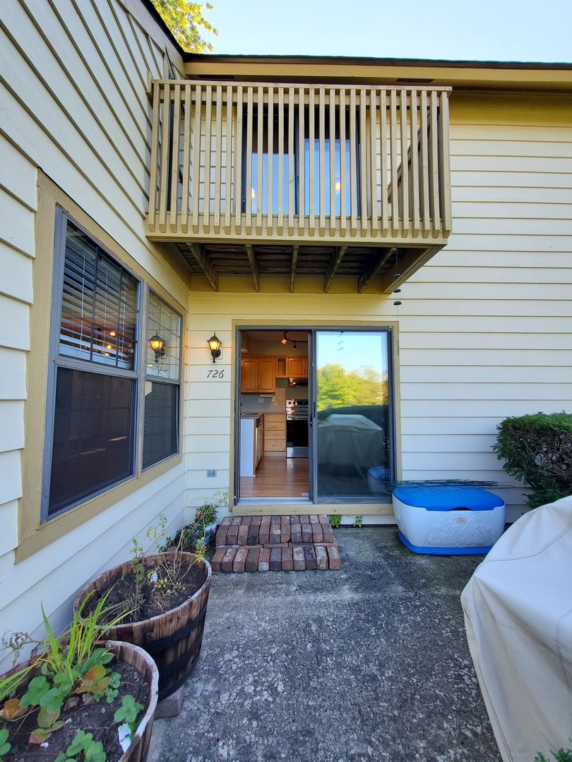 726 Chandler Road Gurnee, IL 60031 - Photo 29 of 43 a view of a porch with furniture and a potted plant