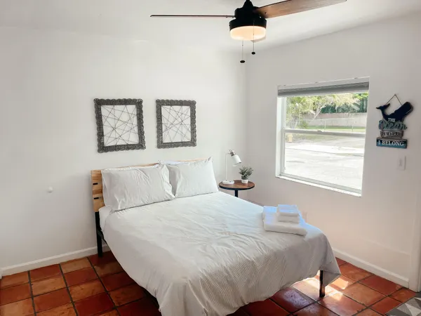 a bedroom with a bed and a window