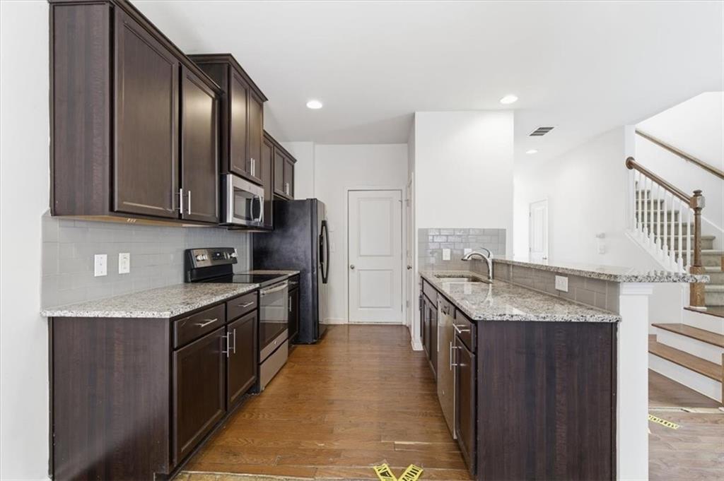 5064 Longview Walk Decatur, GA 30035 - Photo 15 of 30 a kitchen with granite countertop stainless steel appliances and wooden cabinets
