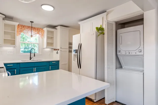 a kitchen with stainless steel appliances a refrigerator sink and cabinets