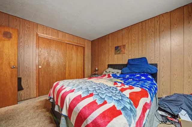 a very nice looking kitchen with granite countertop a stove top oven a sink a dining table and chairs with wooden floor