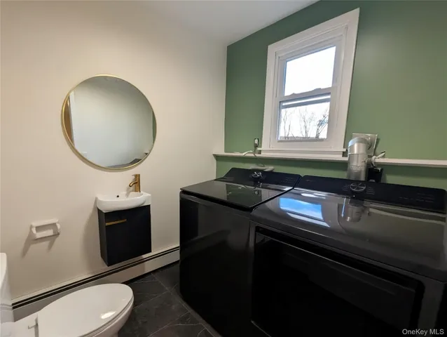 a kitchen with a sink cabinets and a wooden floor
