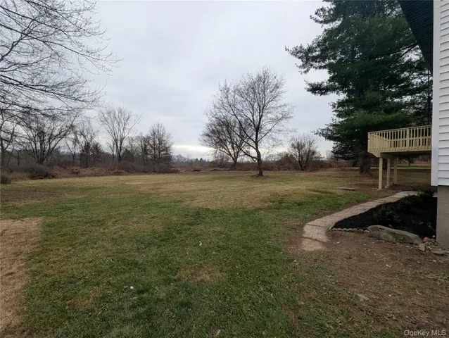 a view of outdoor space with deck and yard