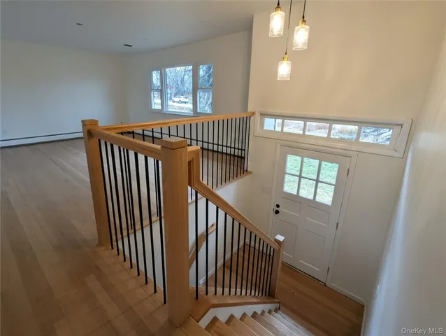 a view of entryway and hall with wooden floor