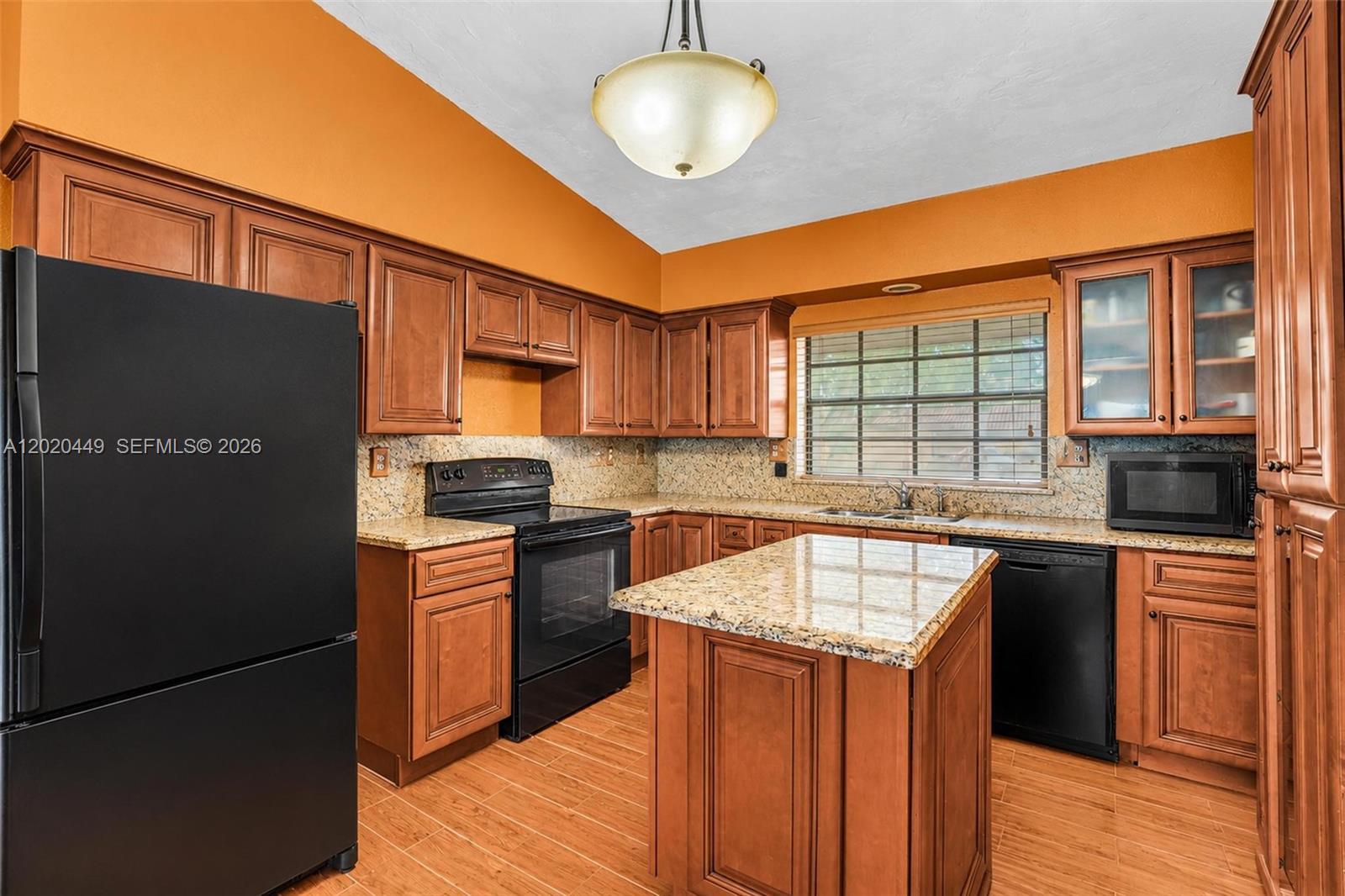 11061 Southwest 163rd Street Miami, FL 33157 - Photo 4 of 42 a kitchen with stainless steel appliances granite countertop a sink stove and refrigerator