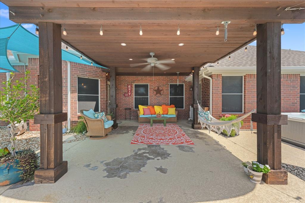 112 Springfield Lane Red Oak, TX 75165 - Photo 26 of 40 Covered patio featuring a wood-finish ceiling, integrated recessed lighting, string lights, and a ceiling fan