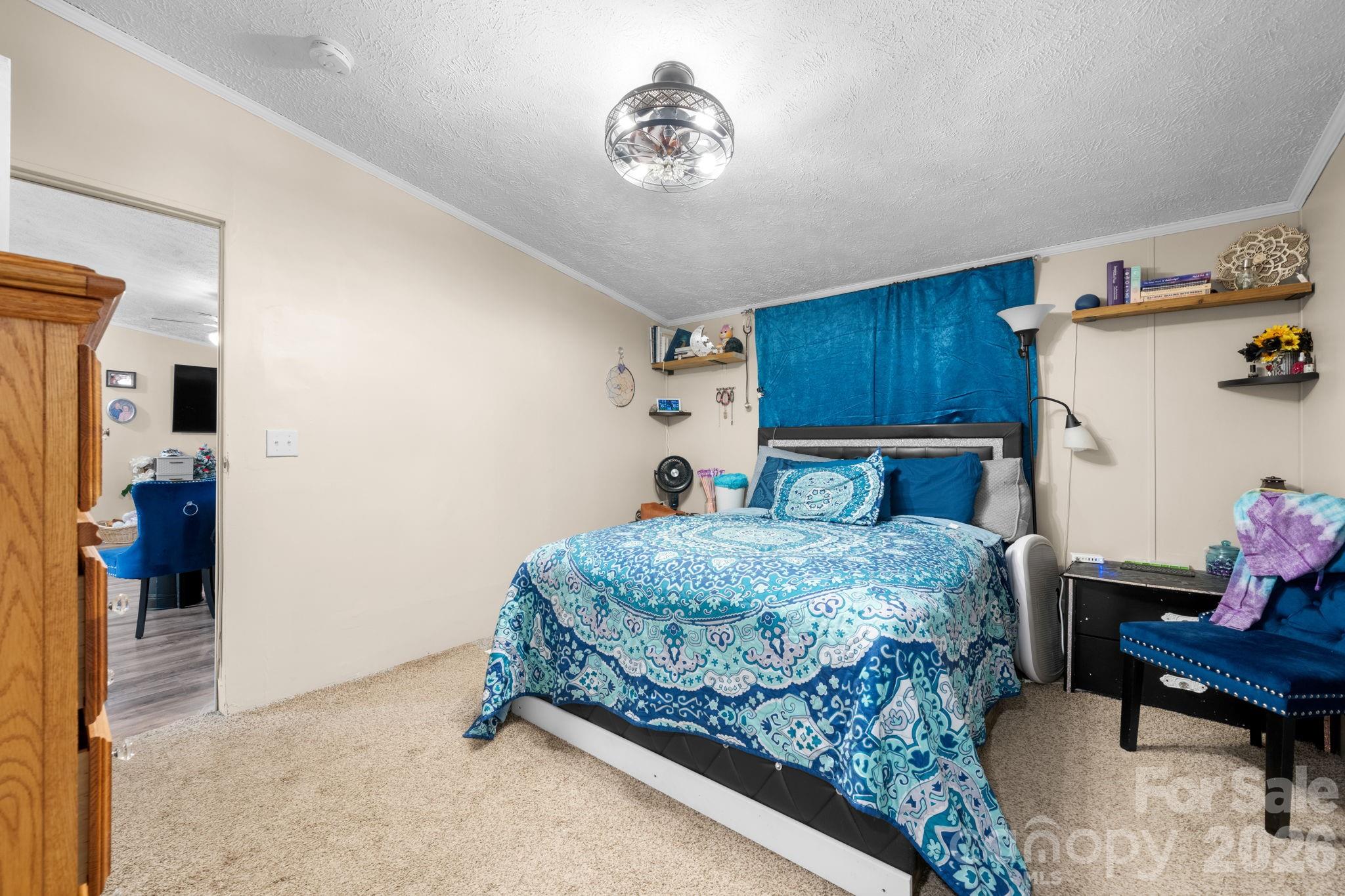 7911 Bailey Road Connelly Springs, NC 28612 - Photo 20 of 32 a bedroom with a bed and a table in it