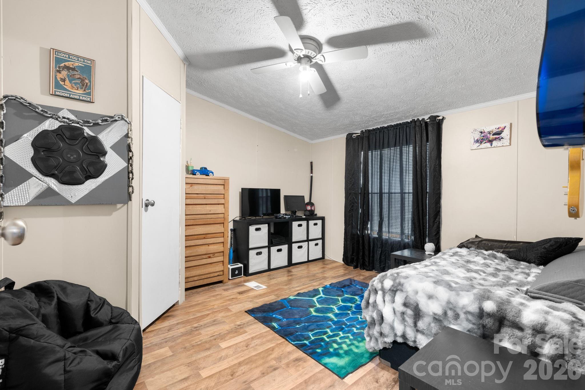 7911 Bailey Road Connelly Springs, NC 28612 - Photo 22 of 32 a bedroom with a bed and a television