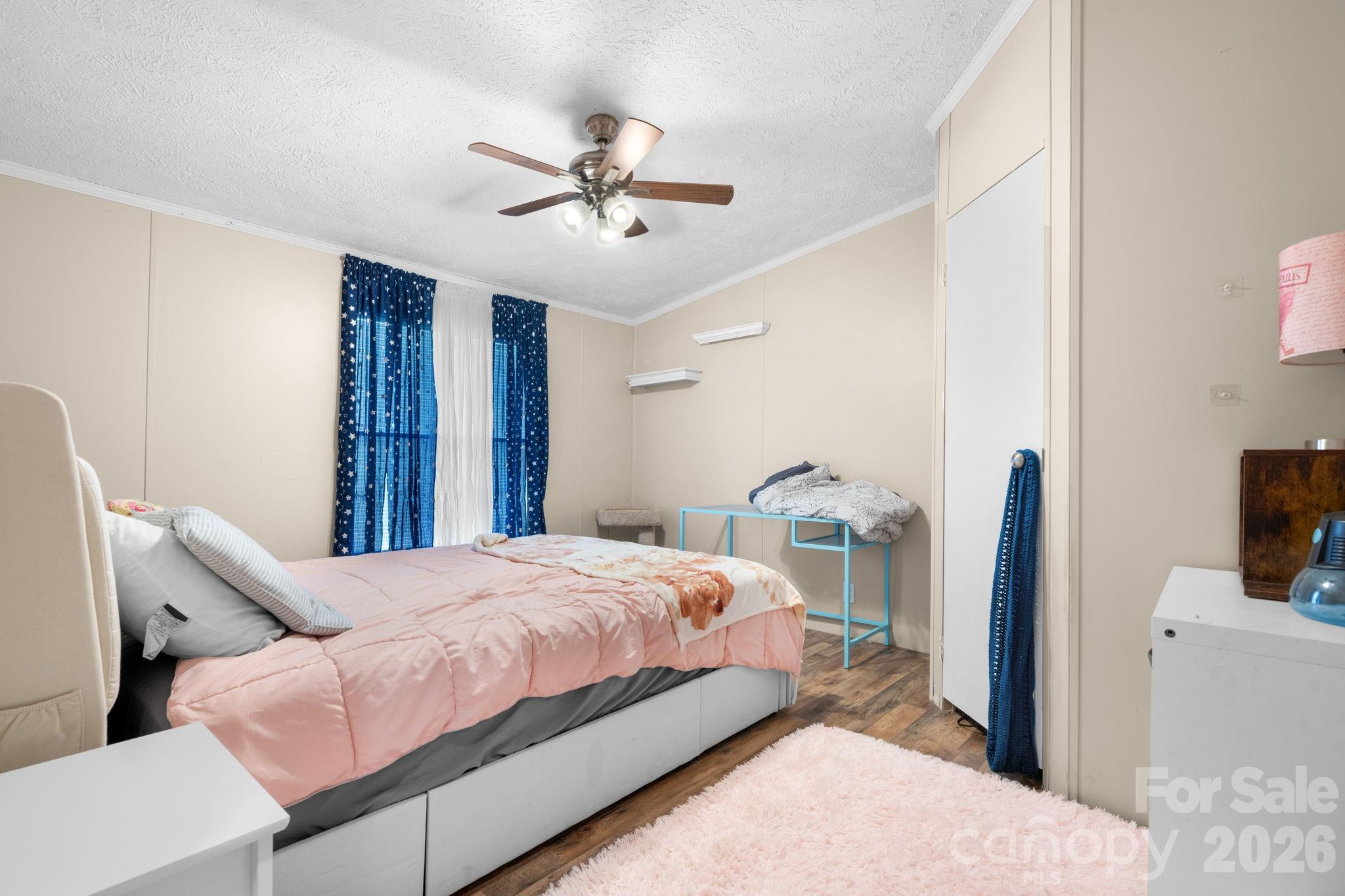 7911 Bailey Road Connelly Springs, NC 28612 - Photo 24 of 32 a bedroom with a bed and a chandelier