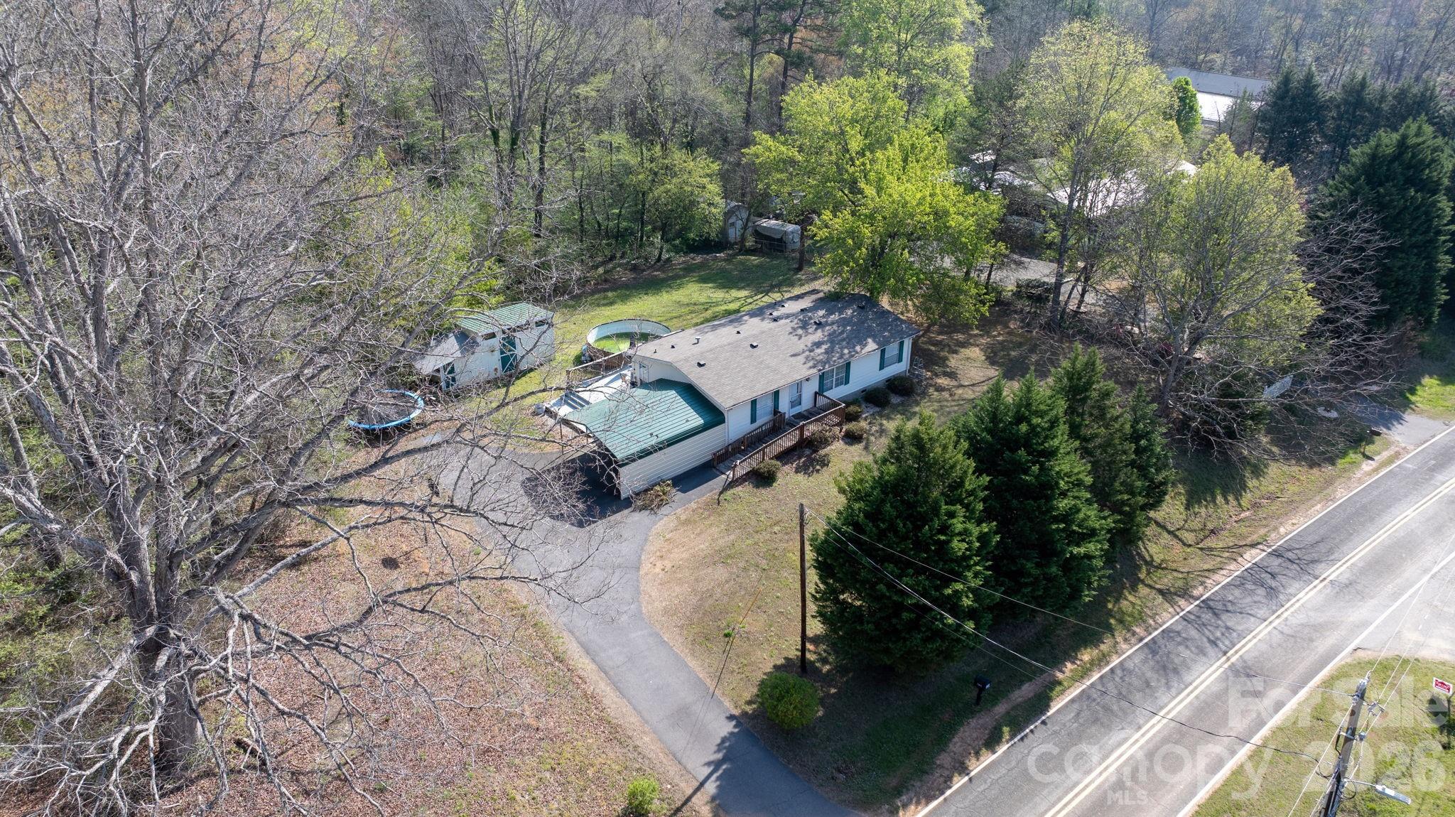 7911 Bailey Road Connelly Springs, NC 28612 - Photo 29 of 32 an aerial view of a house with a yard basket ball court and outdoor seating
