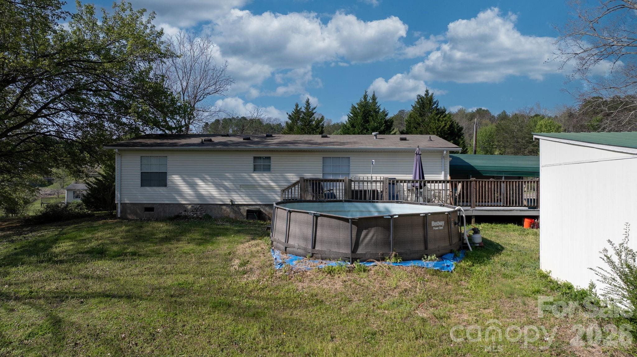7911 Bailey Road Connelly Springs, NC 28612 - Photo 10 of 32 a backyard of a house with table and chairs