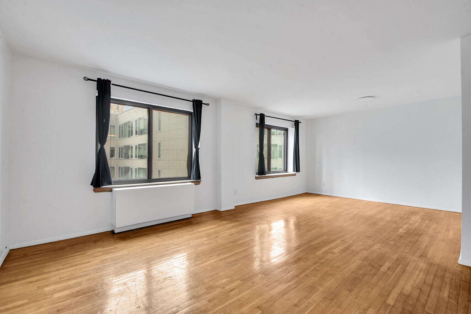 414 West 54th Street, Unit 5B Manhattan, NY 10019 - Photo 1 of 12 a view of an empty room with window