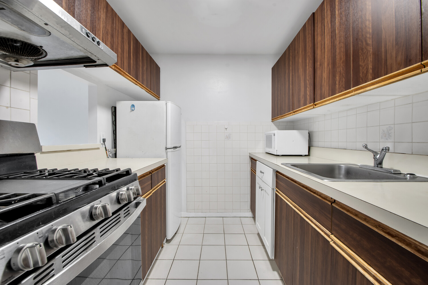 414 West 54th Street, Unit 5B Manhattan, NY 10019 - Photo 5 of 12 a kitchen with a stove and a sink