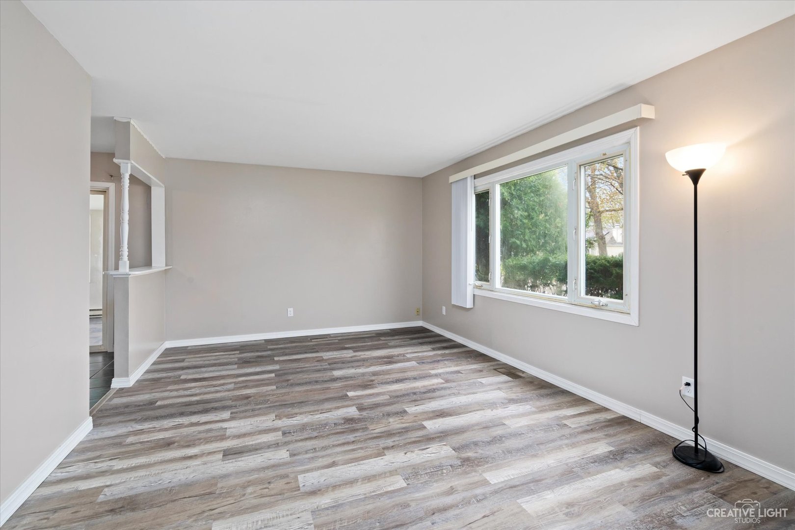 107 Heathgate Road Montgomery, IL 60538 - Photo 3 of 17 a view of an empty room with wooden floor and a window