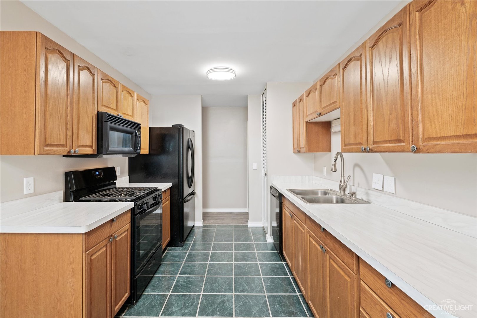 107 Heathgate Road Montgomery, IL 60538 - Photo 5 of 17 a kitchen with stainless steel appliances a sink stove microwave and cabinets