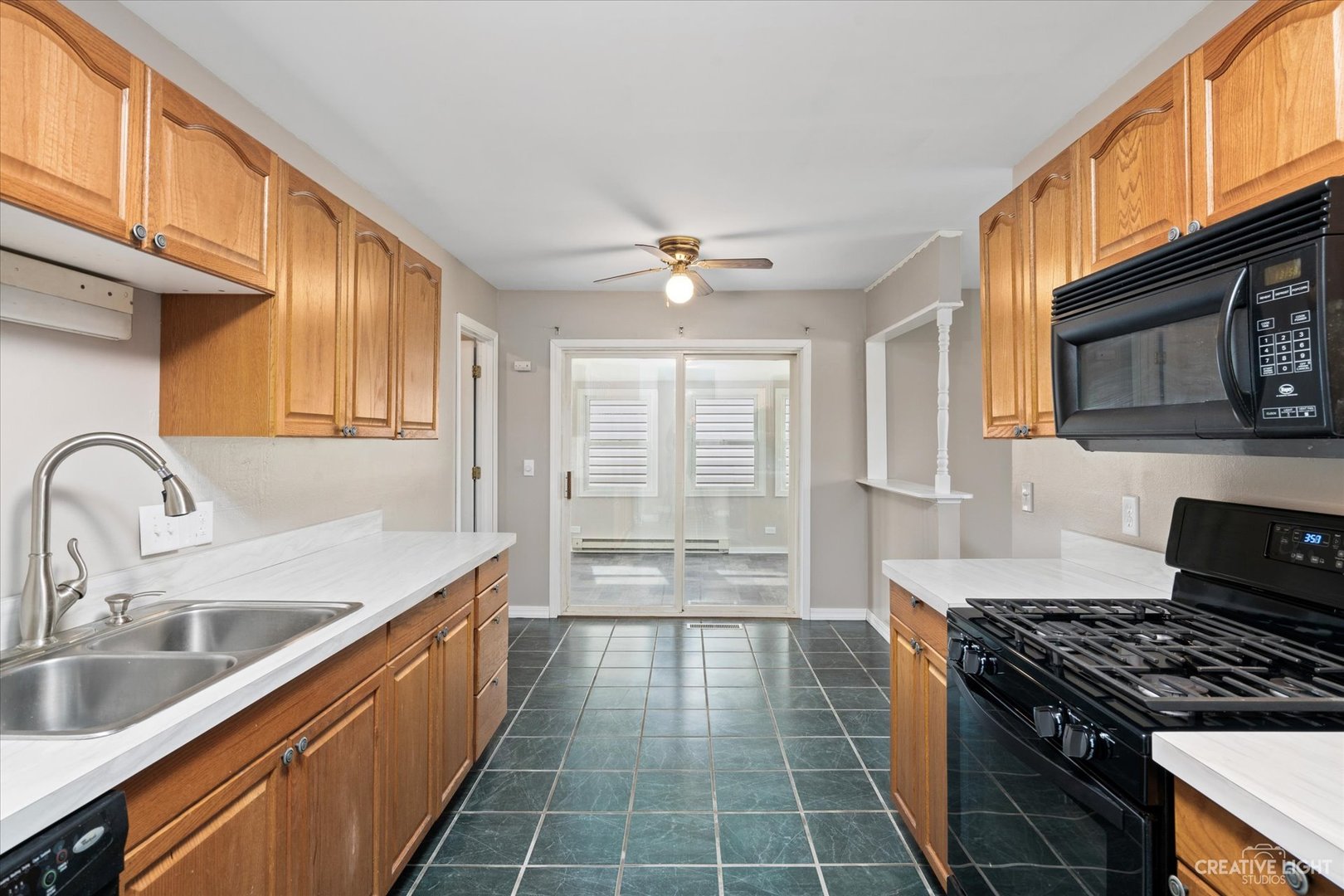 107 Heathgate Road Montgomery, IL 60538 - Photo 6 of 17 a kitchen with granite countertop a stove a sink and a microwave