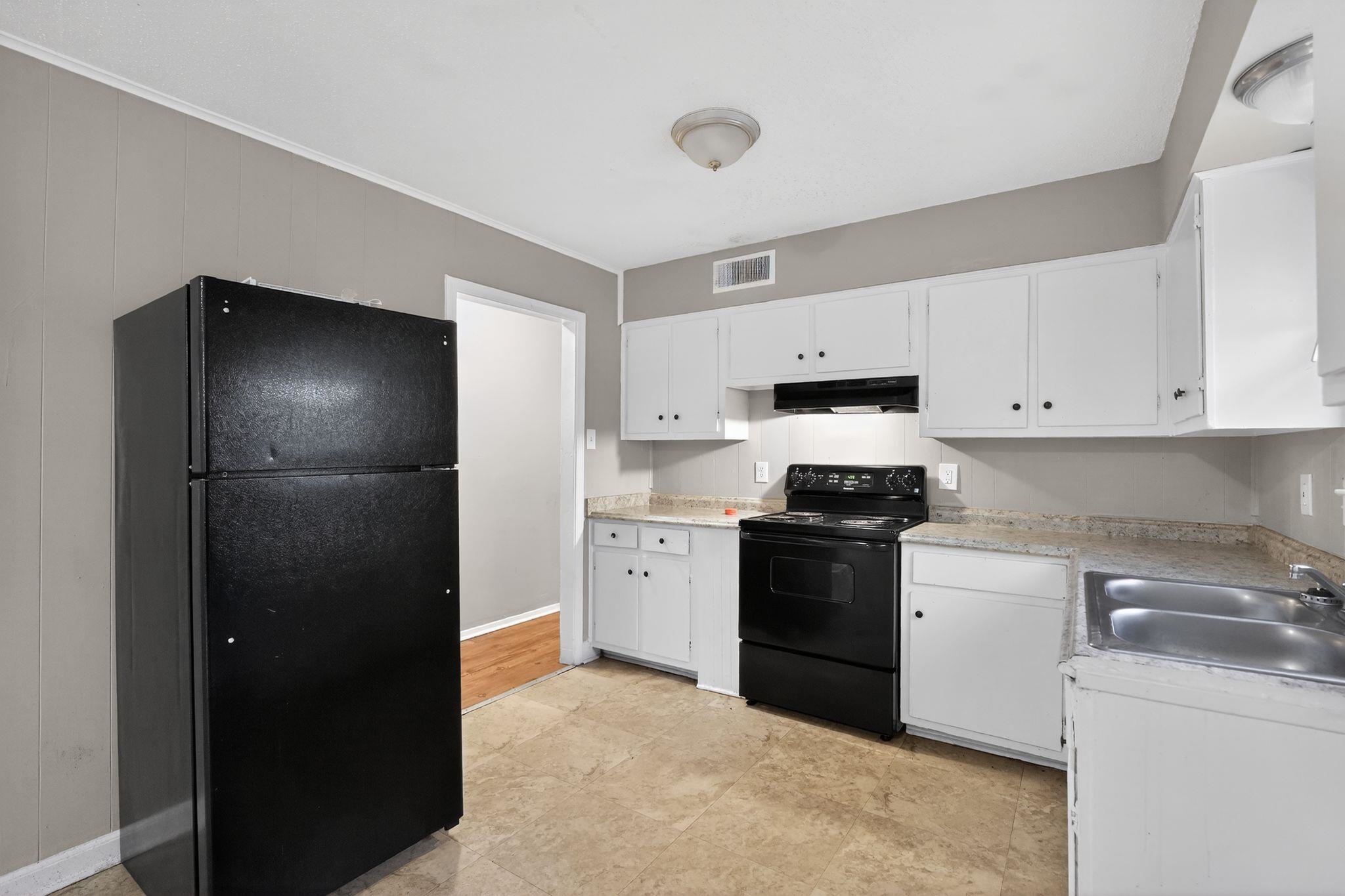 4314 Ford Road Memphis, TN 38109 - Photo 21 of 31 a kitchen with a refrigerator and a stove