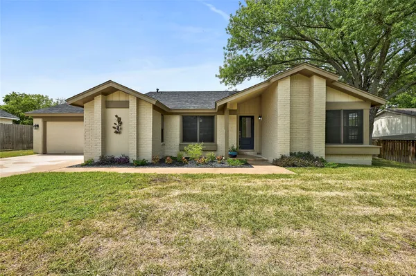 a front view of house with yard and trees