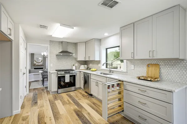 a kitchen with a stove oven and sink