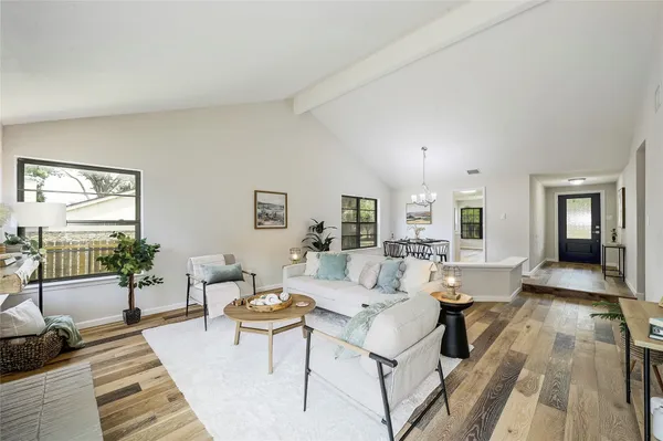 a living room with furniture and wooden floor