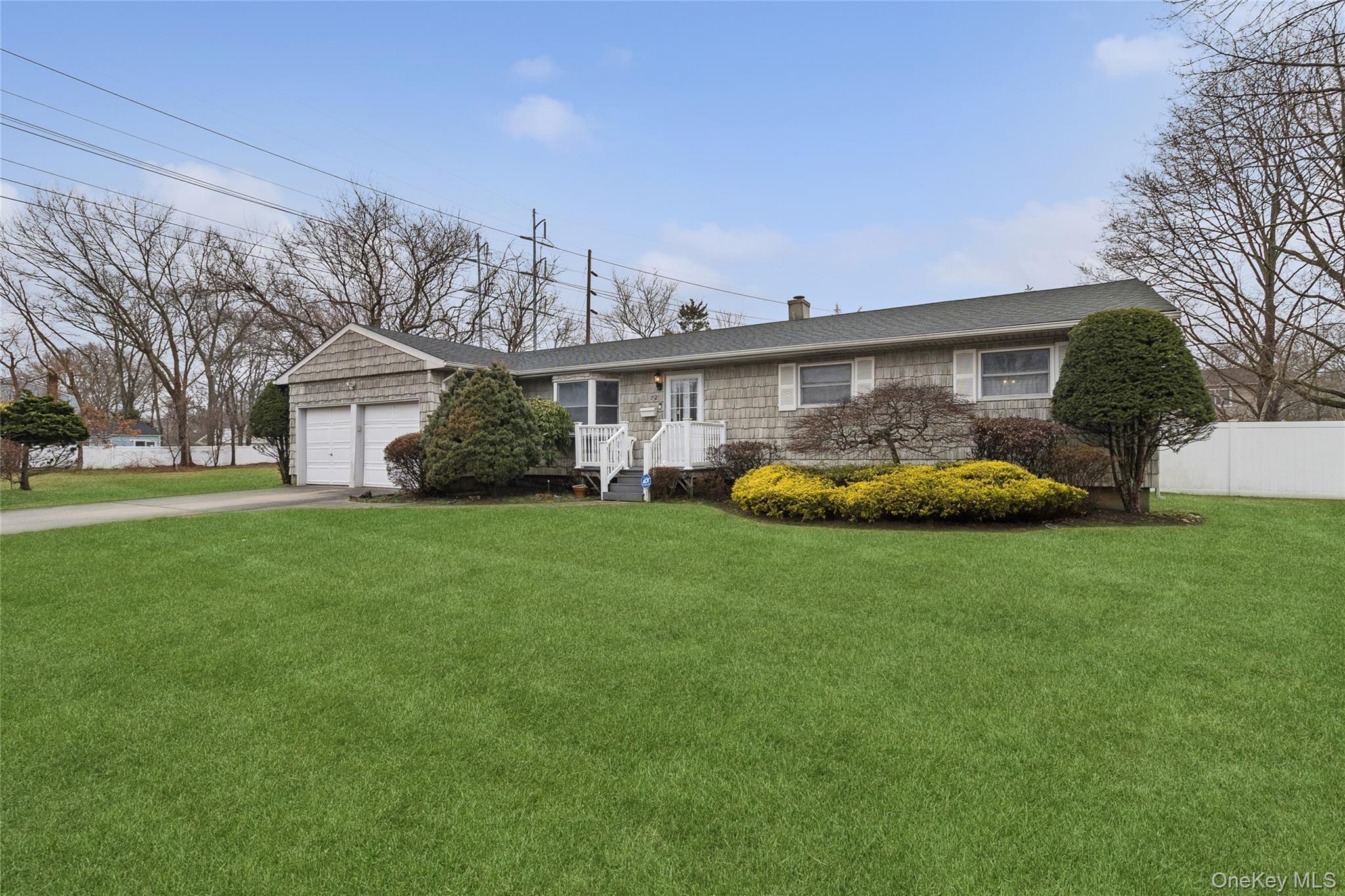 72 Jarvin Road Port Jefferson Station, NY 11776 - Photo 1 of 29 a front view of a house with a garden and trees