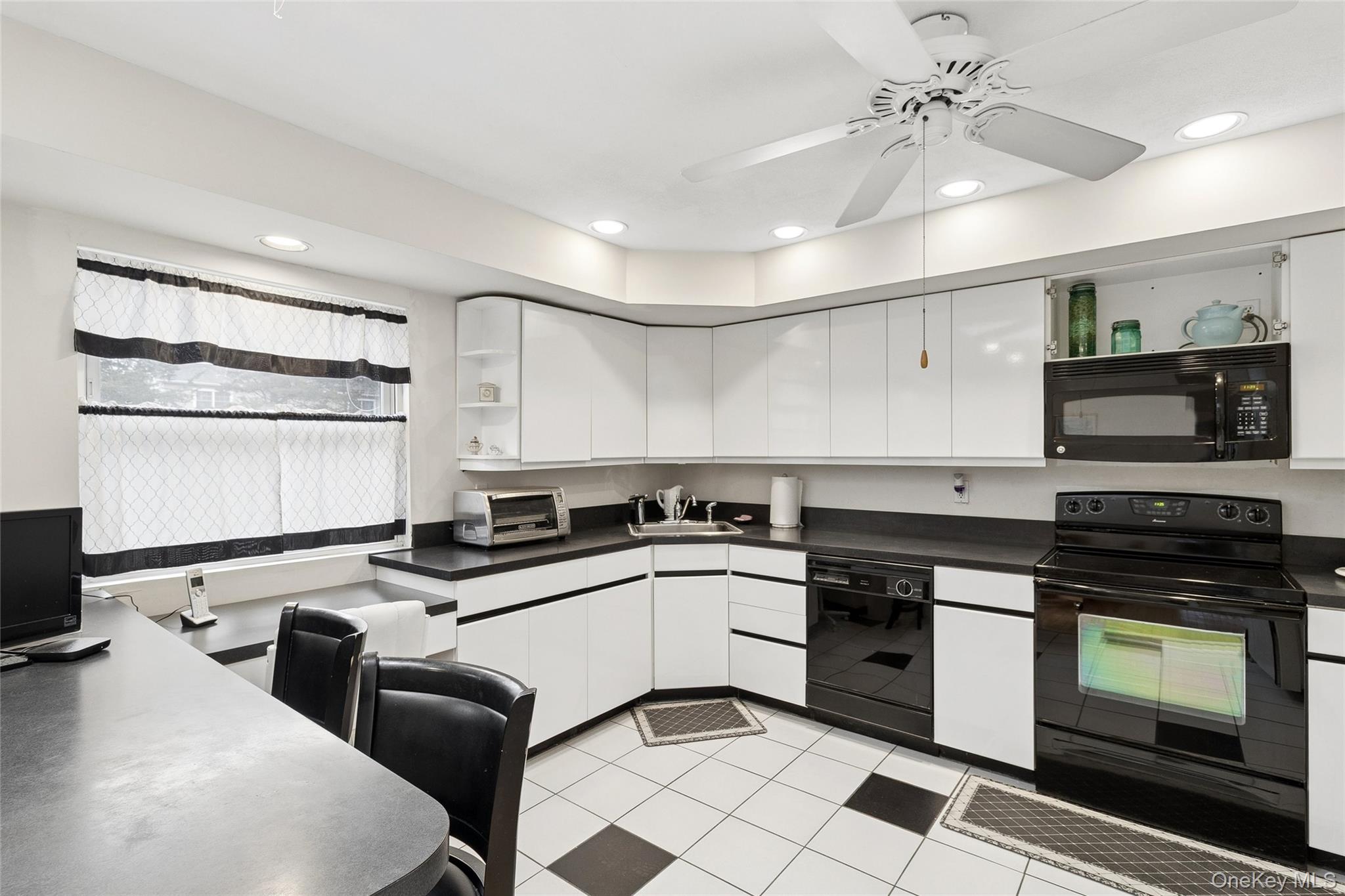 72 Jarvin Road Port Jefferson Station, NY 11776 - Photo 12 of 29 a kitchen with granite countertop a stove sink and cabinets