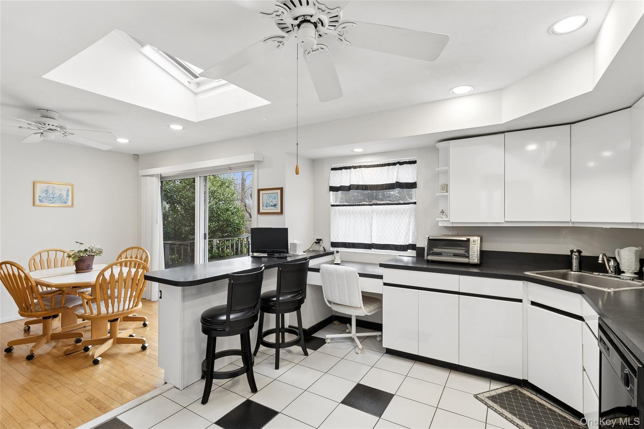 72 Jarvin Road Port Jefferson Station, NY 11776 - Photo 16 of 29 a kitchen with stainless steel appliances a stove a sink a dining table and chairs with cabinets