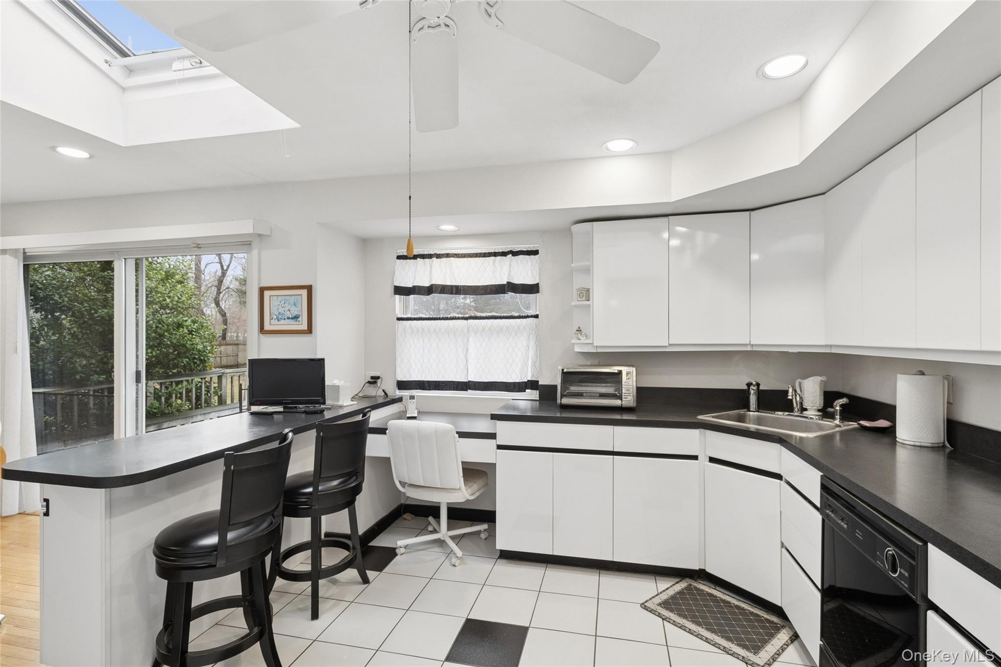 72 Jarvin Road Port Jefferson Station, NY 11776 - Photo 17 of 29 a kitchen with a sink a counter top space cabinets and stainless steel appliances