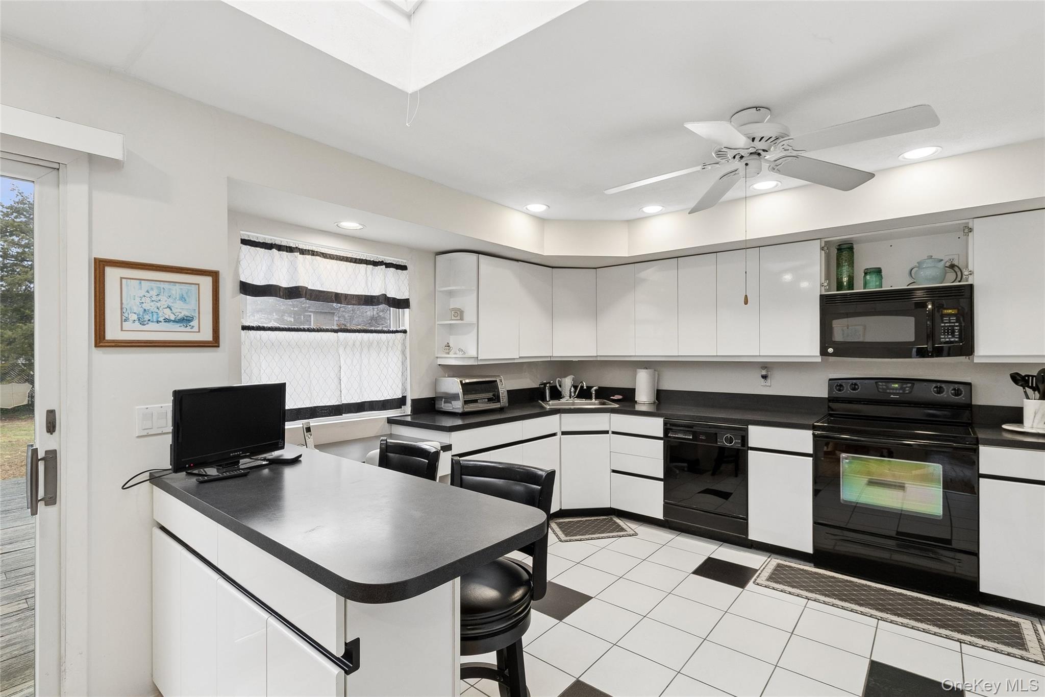 72 Jarvin Road Port Jefferson Station, NY 11776 - Photo 18 of 29 a kitchen with stainless steel appliances granite countertop a stove a sink and a microwave