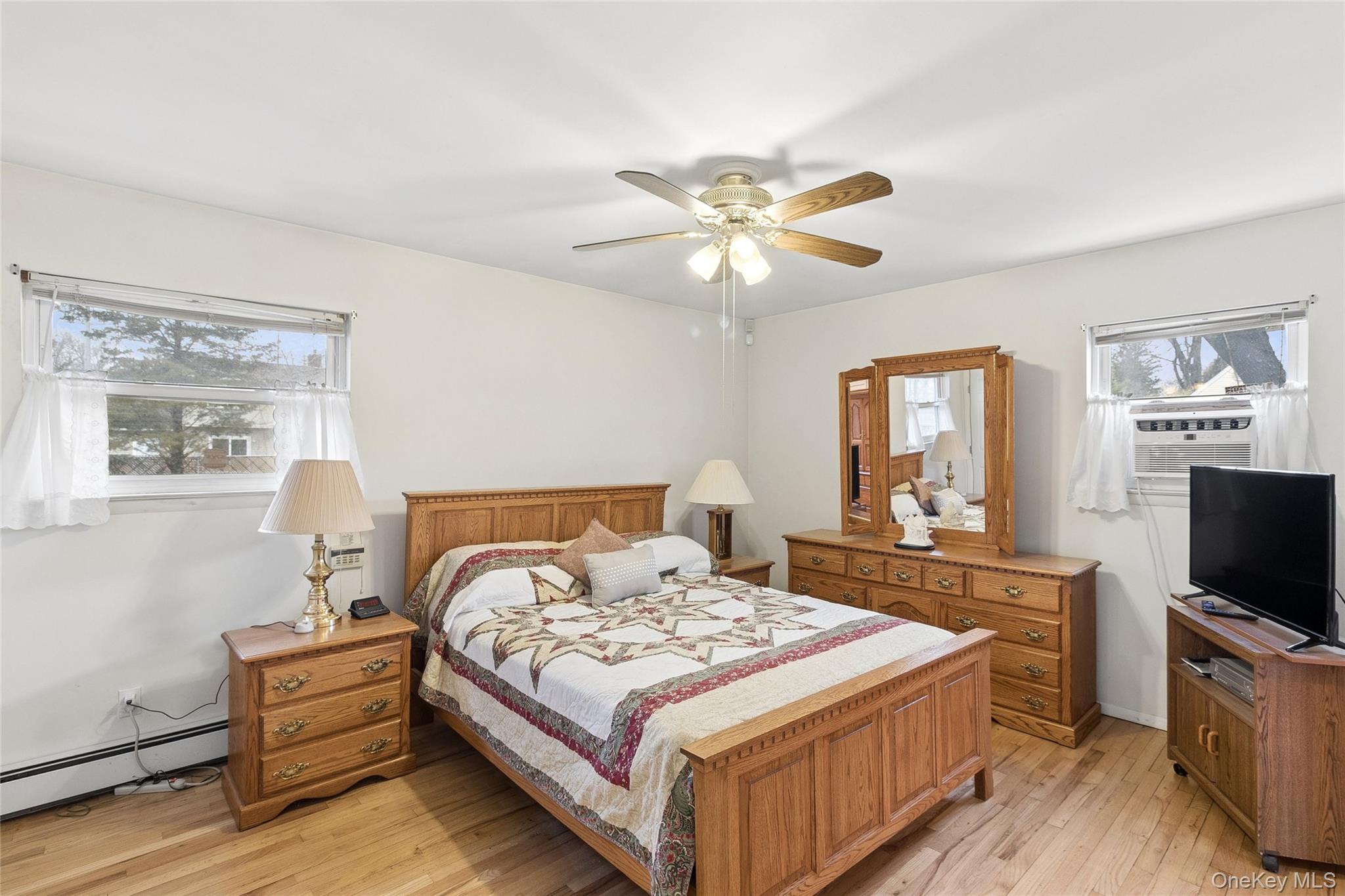 72 Jarvin Road Port Jefferson Station, NY 11776 - Photo 19 of 29 a bedroom with a bed and a flat screen tv