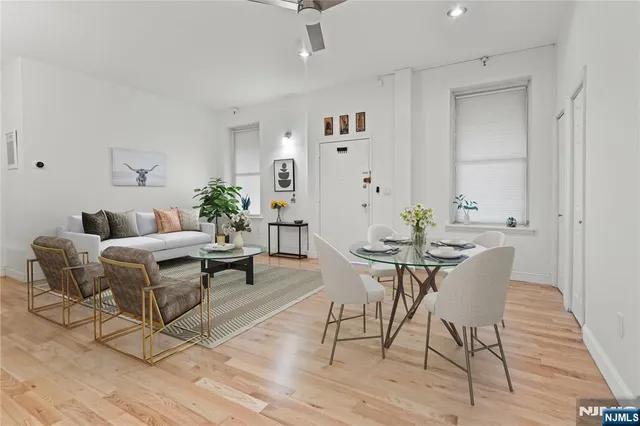 a view of a dining room with furniture and wooden floor