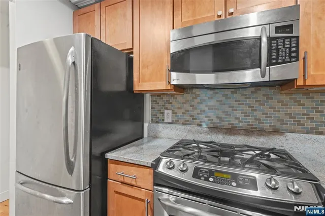 a stove top oven sitting inside of a kitchen
