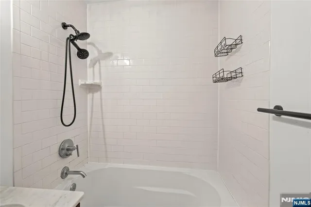 a bathroom with a bath tub with a shower