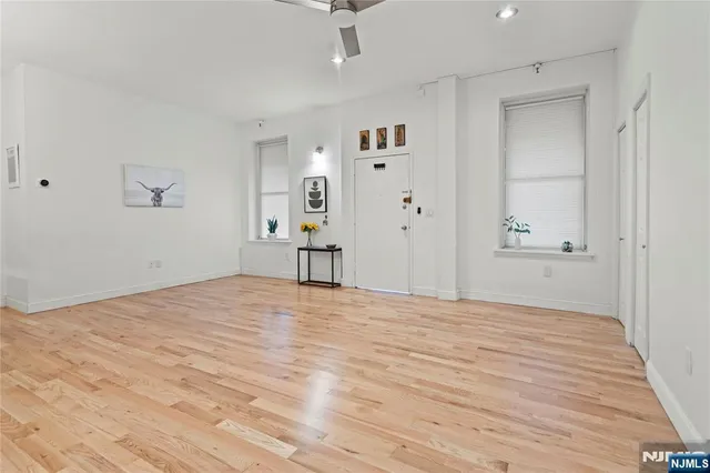 a view of empty room with wooden floor