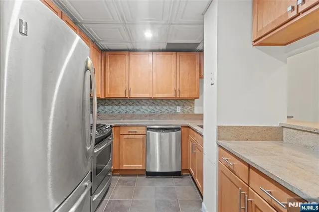 a kitchen with granite countertop white cabinets and white appliances