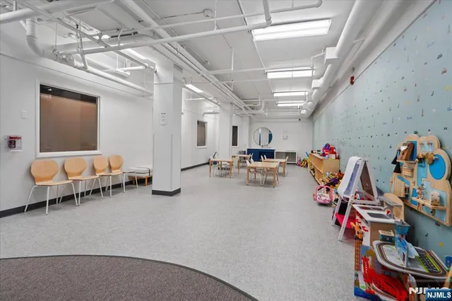 a room with a book shelf and wooden floor