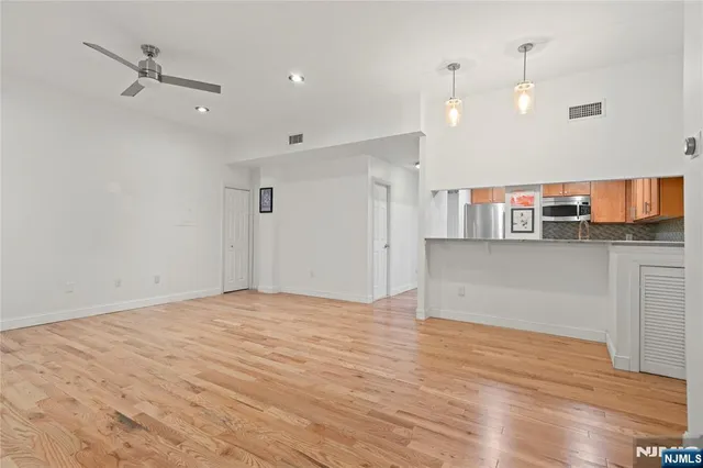 a view of a kitchen with a dishwasher and a wooden floor