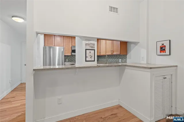 a view of kitchen with wooden floor and window