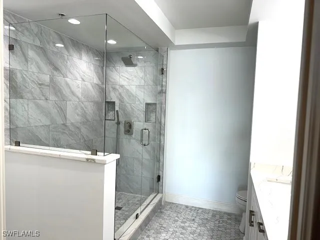 a large bed sitting in a bedroom next to a window