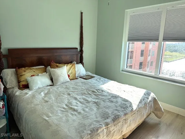 a bathroom with a granite countertop sink toilet and mirror