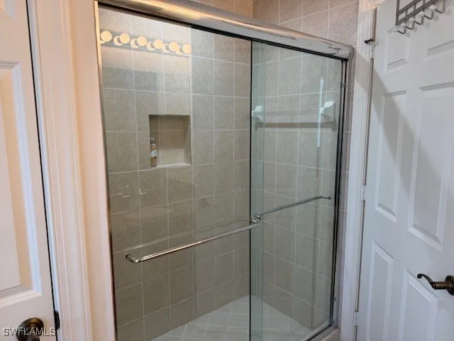 a room with pool table and windows