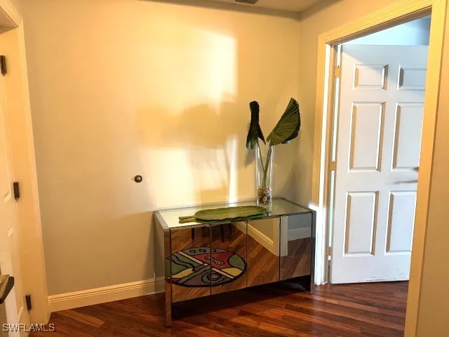 a kitchen with wooden floors and a microwave
