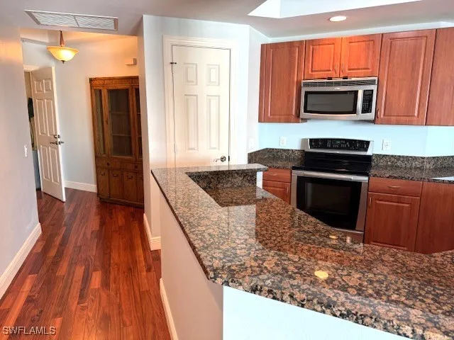 a kitchen with a sink stove and refrigerator