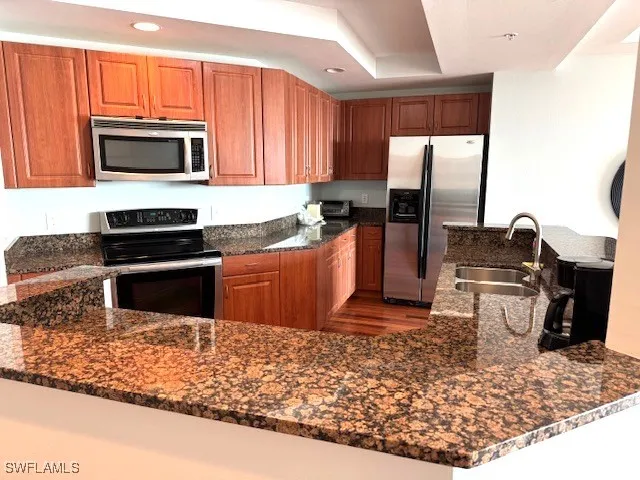 a kitchen with a table chairs a stove and a refrigerator