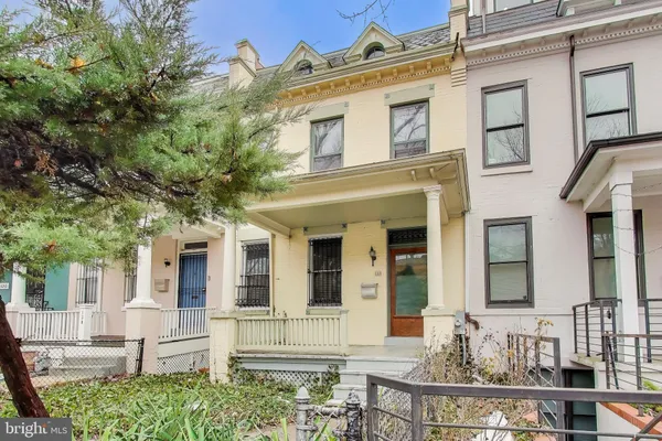 front view of a brick house with a large windows